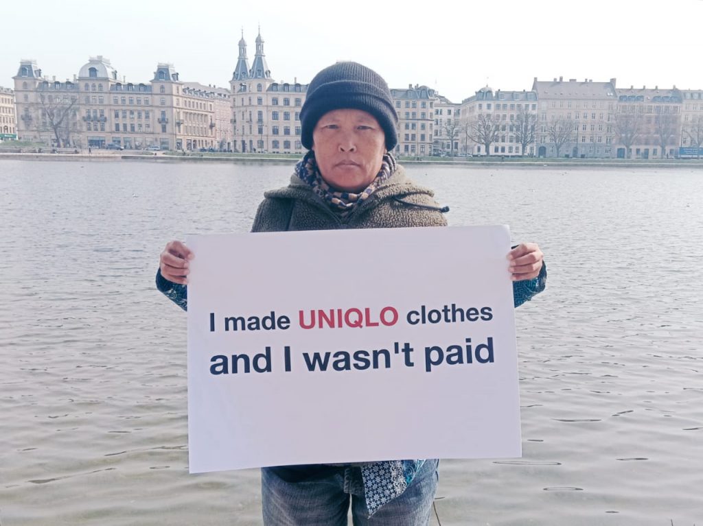 Living wage myth | Person holding sign that ays: I made Uniqlo clothes and I wasn't paid