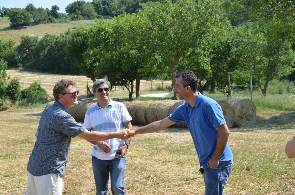 Charles Redfern and pasta suppliers shake hands