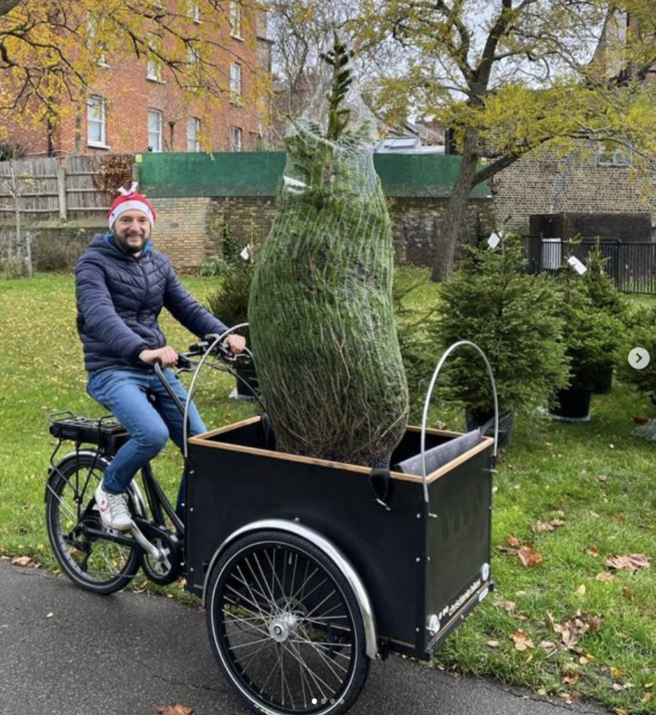 Man with tree on bike